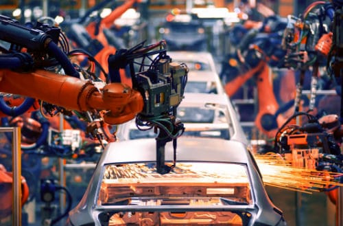 Production line for motor vehicles with automated robotic arms