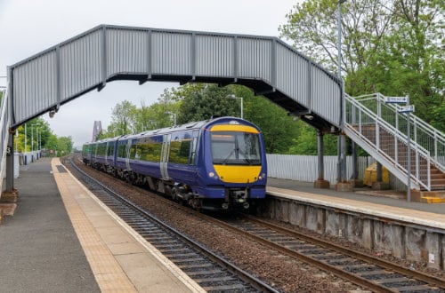 Train running down a train line showing our part supplying the rail industry with electronic and electromechanical parts