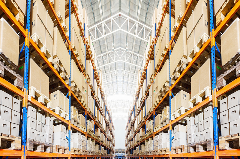 homepage_warehouse_excess_stock Shelves stacked with boxes highlighting the need for excess inventory management.